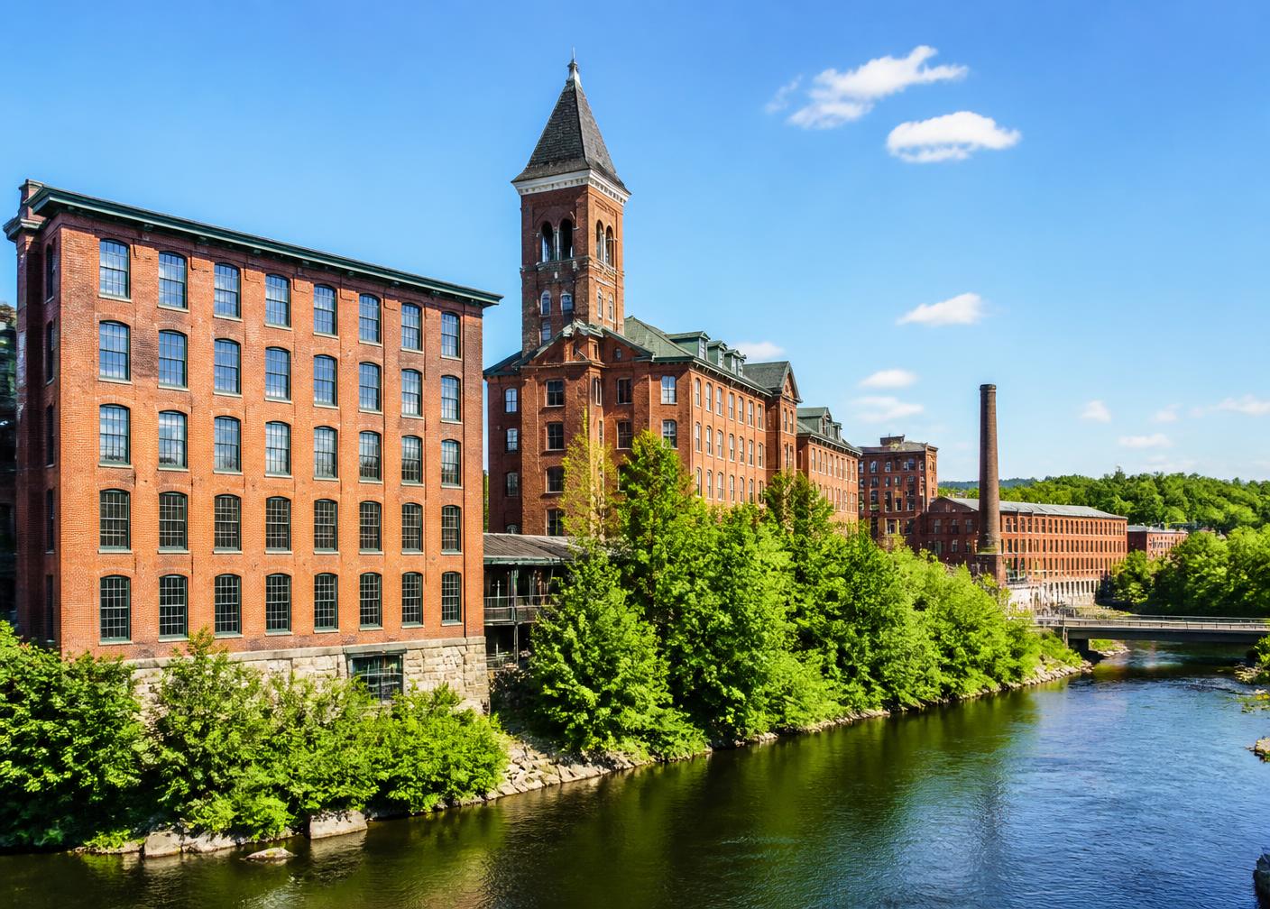 Historic red brick Amoskeag mill buildings along the Merrimack River in Manchester, New Hampshire